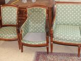 four chairs and a couch in a room