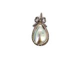 a white pearl and diamond pendant with a bow on it
