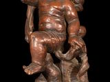 an image of a statue of a child sitting on a tree stump