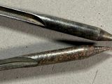 two tools that are sitting on a table