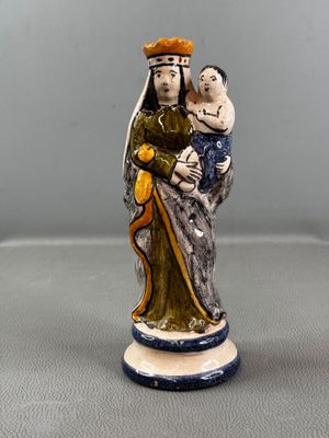 figurine d'une femme tenant un enfant dans ses bras