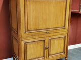 an antique wooden cabinet with marble top in a room