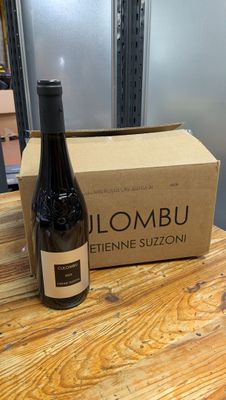 a bottle of wine sitting on a table next to a box