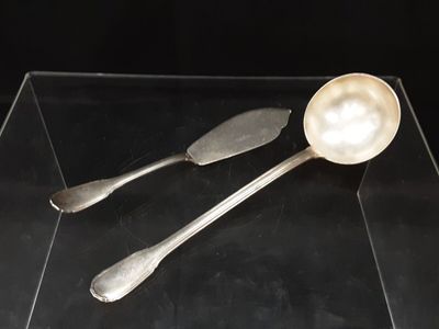 two spoons that are sitting on a glass table