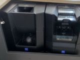 two computers sitting on top of a desk next to each other