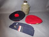 three hats and a canteen on a table