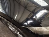 a reflection of a man in a mirror on the side of a car