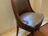 a brown chair that is sitting in front of a window
