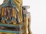 a statue of a woman sitting on a chair