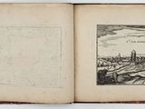 an open book with a drawing of a city in the middle
