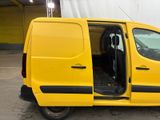 a yellow van with its doors open in a parking lot