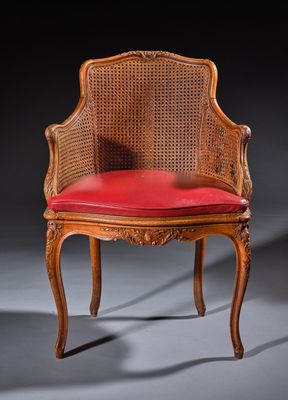 an old chair with a red cushion on top of it