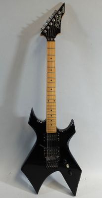 a black electric guitar that is sitting on a white surface