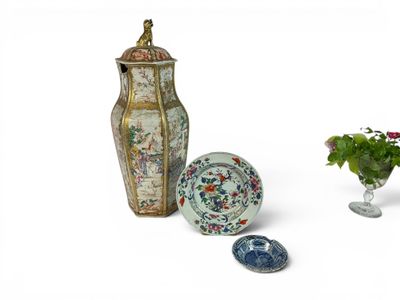 three vases and a plate sitting next to each other on a table