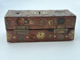 a small wooden box with metal decorations on it