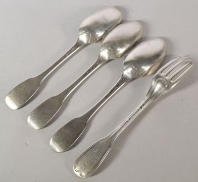 five silver spoons and a fork are lined up on a table