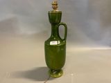 a green vase with a light on top of it