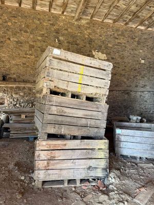 a pile of wooden pallets sitting in a room