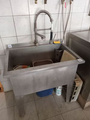 a stainless steel sink in a kitchen with a faucet and a faucet