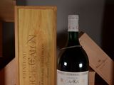 a bottle of wine that is sitting next to a wooden box