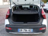 a white car with its trunk open in a parking lot