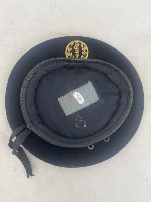 a black hat that has a gold emblem on it
