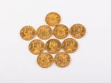 a pile of gold coins on a white surface