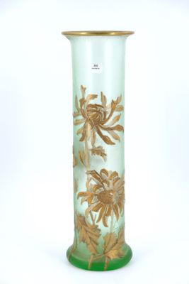 a green vase with gold flowers on it