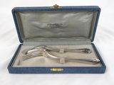 a silverware set in a blue case on a white surface