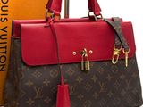 a louis vuitton handbag with a red and brown color