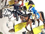 many figurines of men riding horses with signs on them
