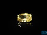 a yellow diamond on a black surface in the dark