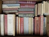 a box full of old books sitting on top of each other