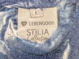 a close up of a blue sweater with a label on it