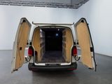 a white van with its doors open in a room