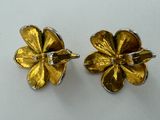 two gold flower earrings with diamonds on them