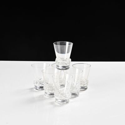four shot glasses and a shot glass sitting on a table