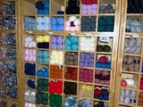 many balls of yarn on the shelves in the store