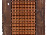 a close up of a wooden window with a lattice pattern on it