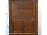 an old wooden cabinet with a drawer underneath it