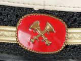 a close up of a hat with a red and gold emblem on it