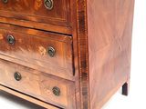 a wooden chest of drawers with a marble top