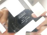 a close up of a person holding a cell phone in front of a mirror