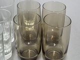 four glasses sitting next to each other on a table