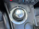 a close up of a car ' s dashboard with a steering control