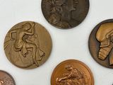a lot of coins that are on a white surface