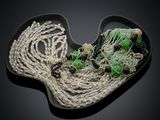 a black plate with a bunch of beads on it