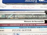 many books stacked on top of each other on a table