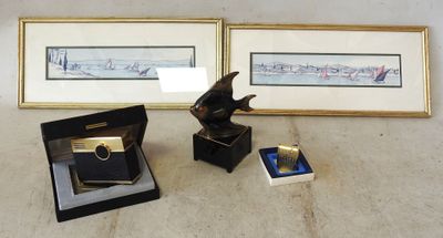 two framed pictures of a bird on a table next to a box with a lighter