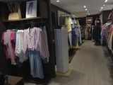a picture of a clothing store with clothes on display